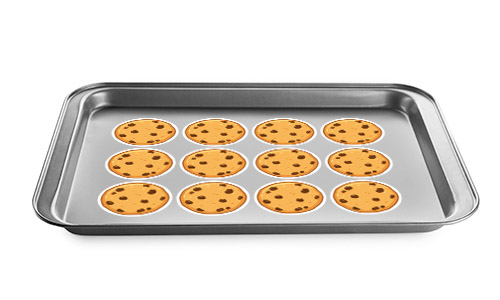 Baking sheet wit chocolate chip decal cookies on it.