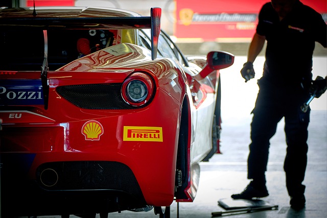 red Ferrari race car with 2 yellow and one blue car decals 