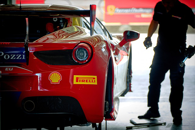 red ferrari with two yellow decals, one blue decal, and one red decal